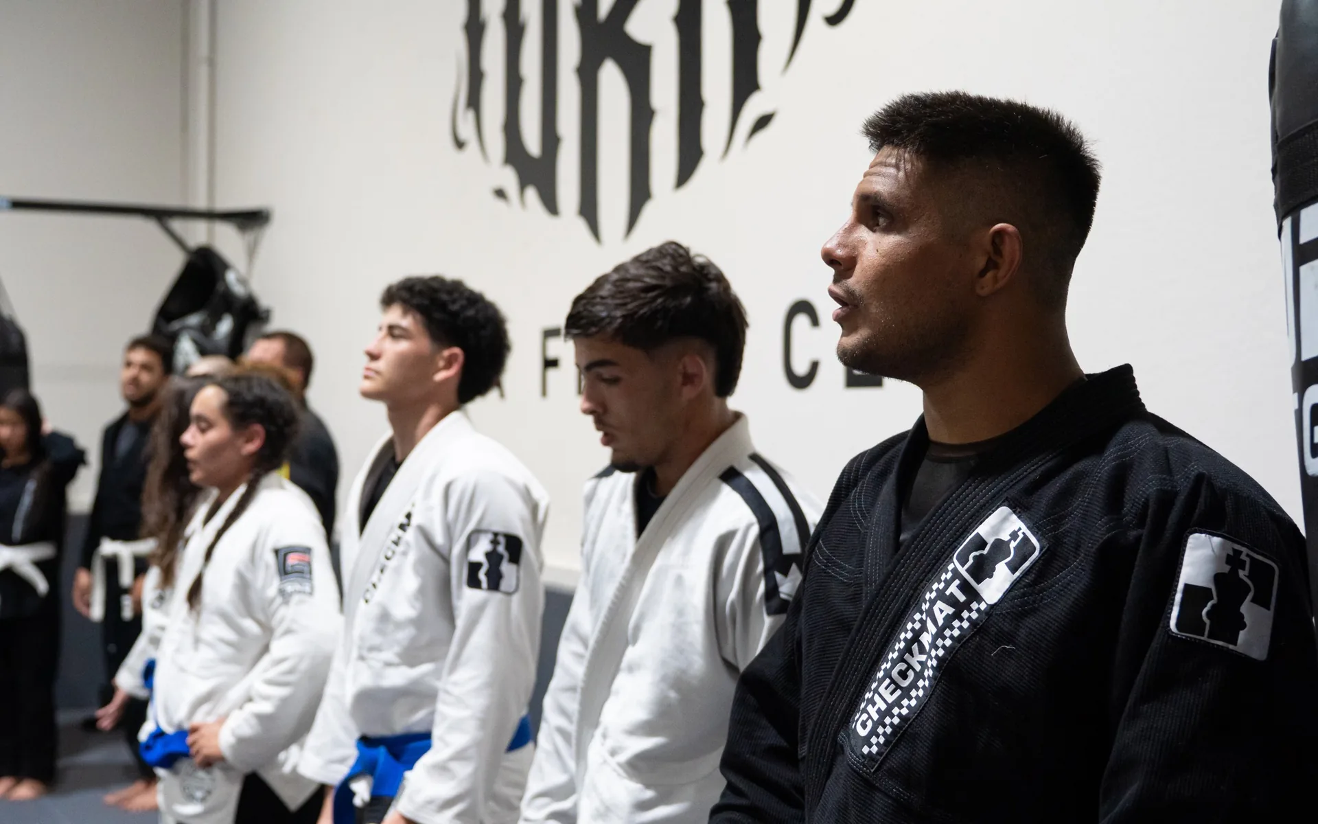 The current Fúria Fight Club Brazilian Jiu-Jitsu team lined up on the mat