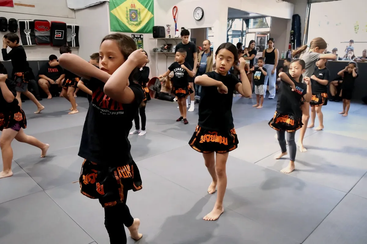Kids practicing Muay Thai technique in class